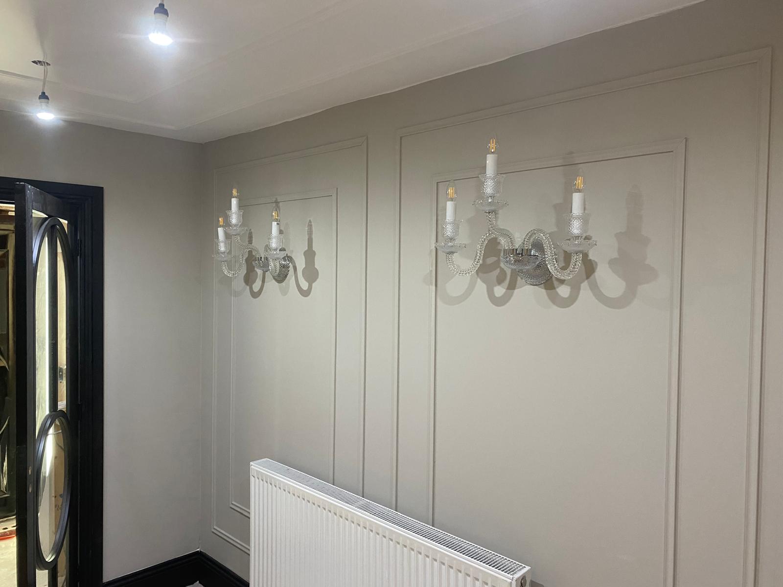 Pair of crystal wall sconces in a residential hallway, lighting design