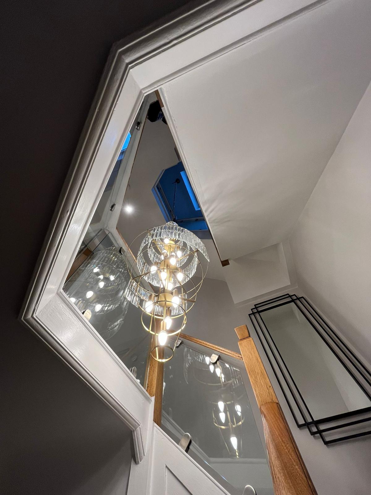 Ornate chandelier installed in a stairwell, domestic feature lighting